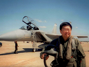 Photo of Dr Hsu with F-15 plane