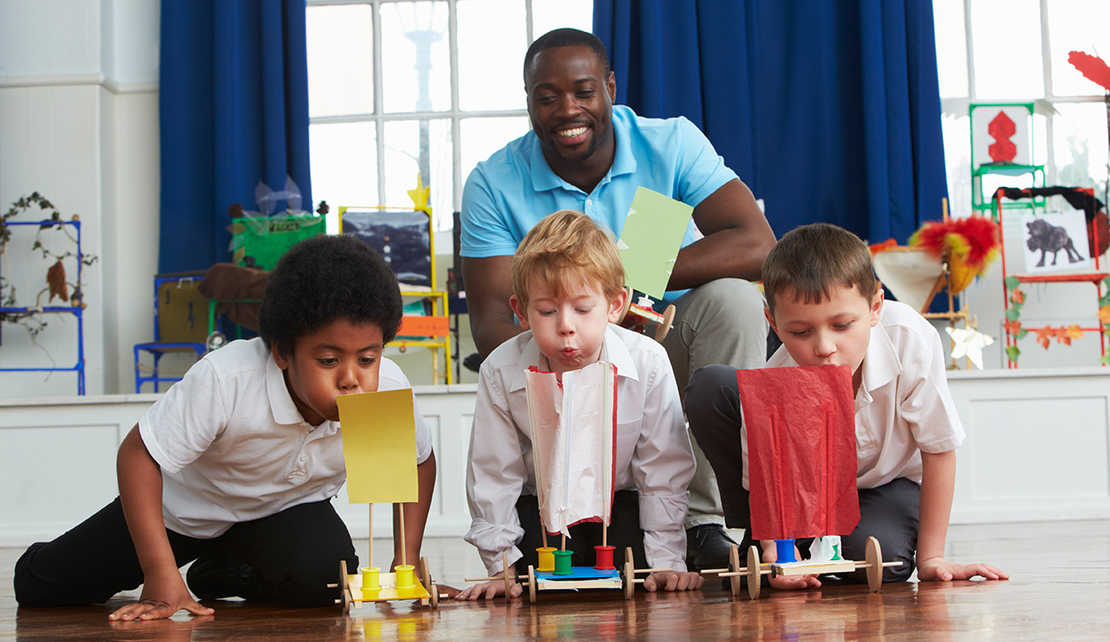 stock image of boy students in science class with teacher
