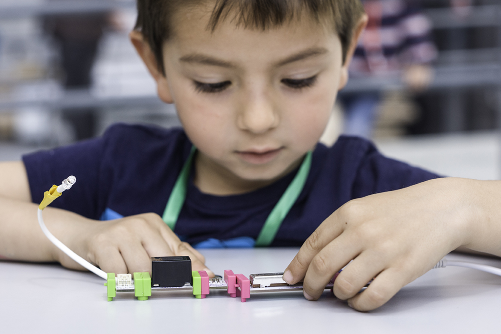 Stock image of little boy experimenting with circuits in science class