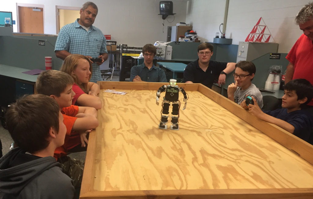 Students with miniature robot for Hsu Educational Foundation
