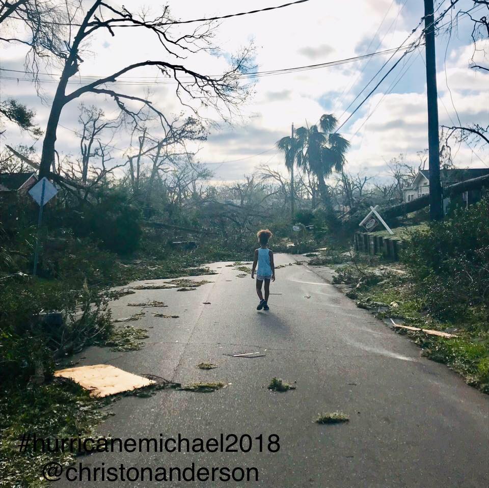 Photo of child walking down a street with hurricane Michael damage by Christon Anderson Art